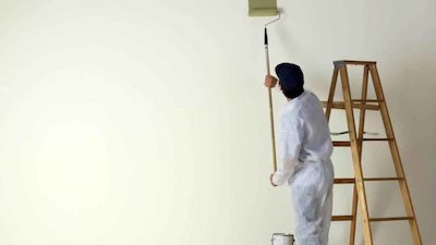 Man-painting-wall-with-roller-e1591923981339